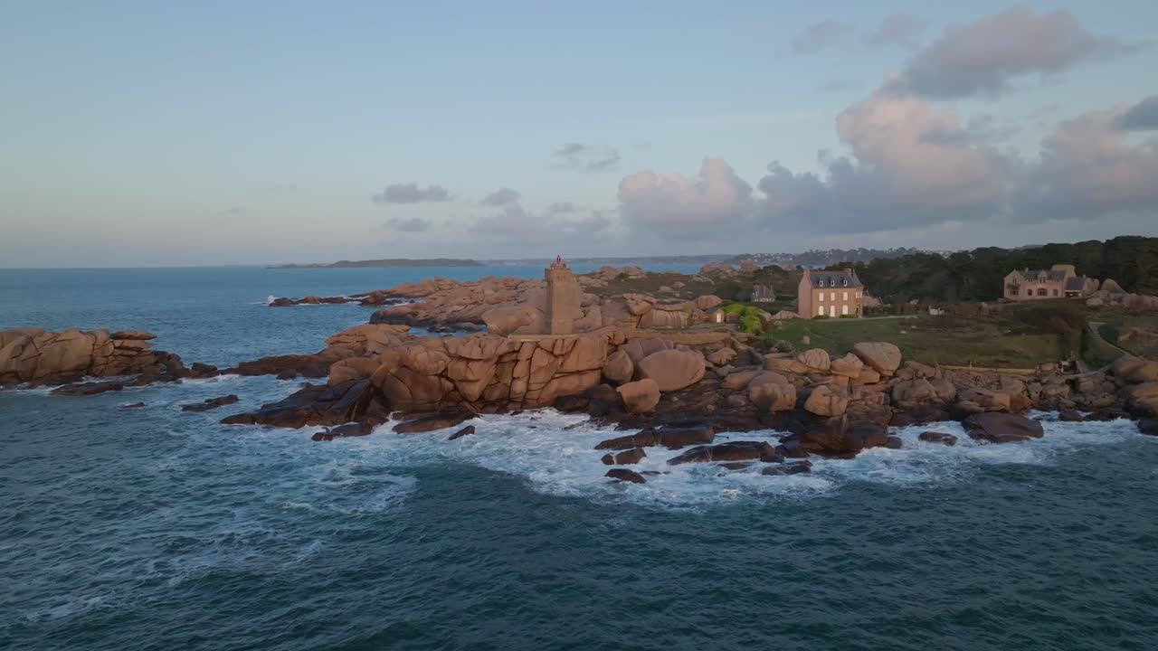 Pull-Back shot of Phare Du Mean Ruz Lighthouse in Bretagne France during sunset