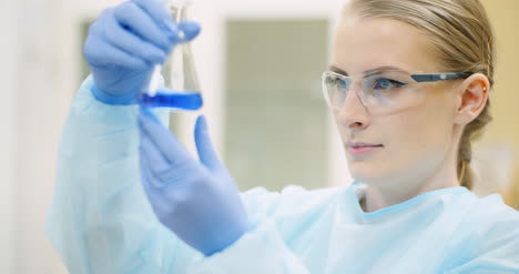 female scientist with a pipette analyzes a liquid at laboratory