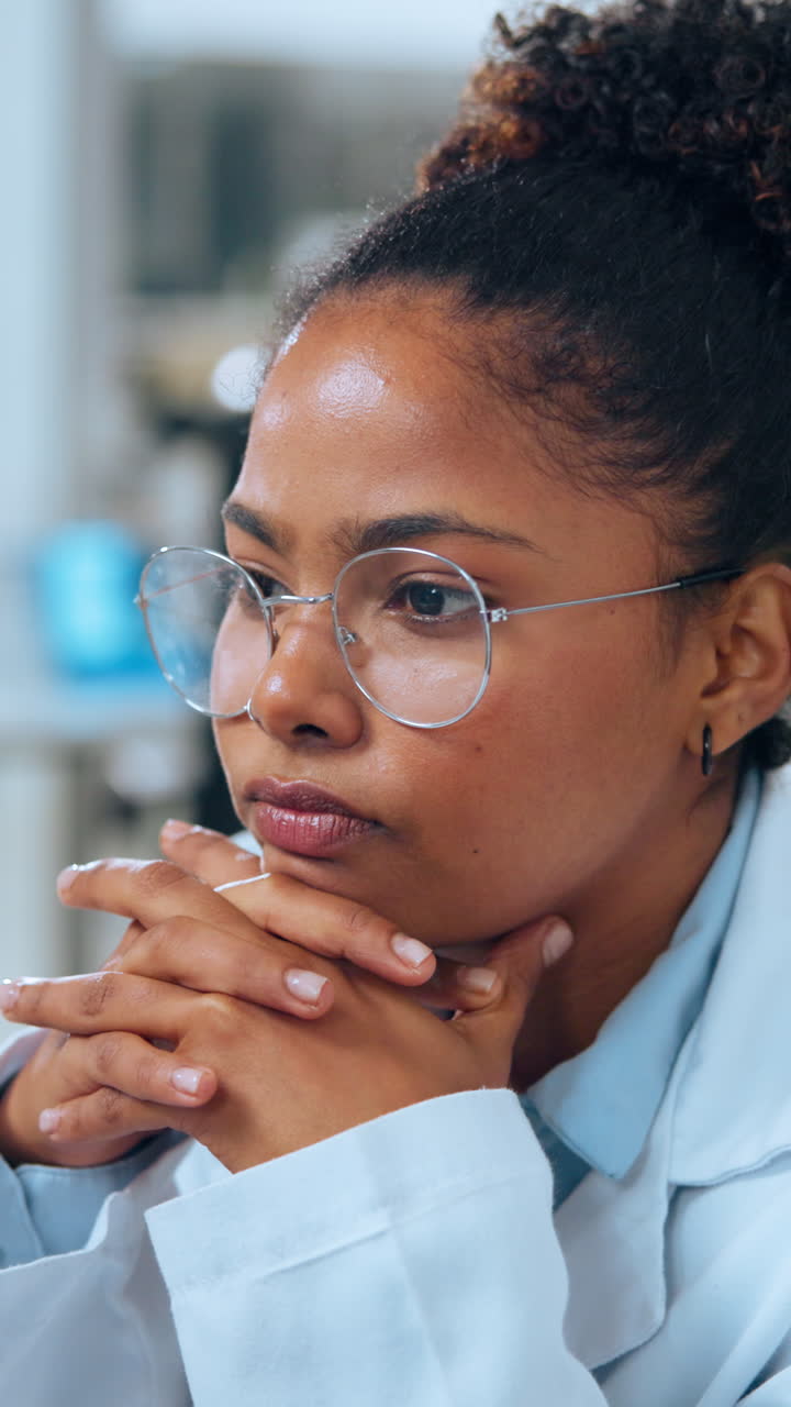 Close-up of Thoughtful Young Woman Scientist in Lab