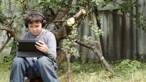 teenager in earphones using touchpad outdoor