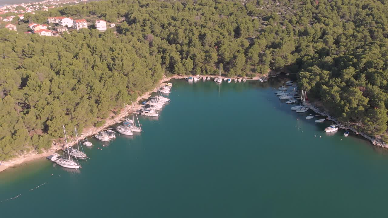 Drone fly over a small hidden Harbour in the Adriatic sea Croatia with wild nature and luxury yacht boat