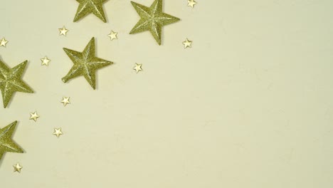 blinking glitter stars for christmas on left corner on beige background. stop motion