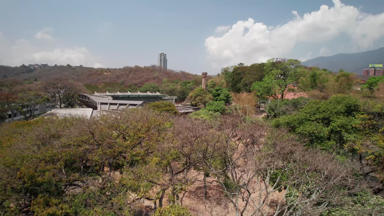 The ucv campus, showcasing pools and natural landscape with hills, aerial view