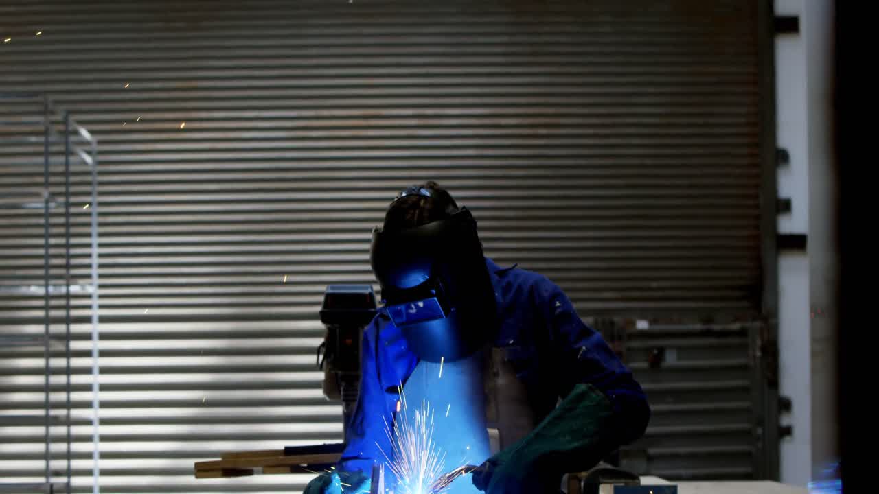 Female welder using blowing torch on a rod 4k