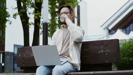 man working on laptop outdoors