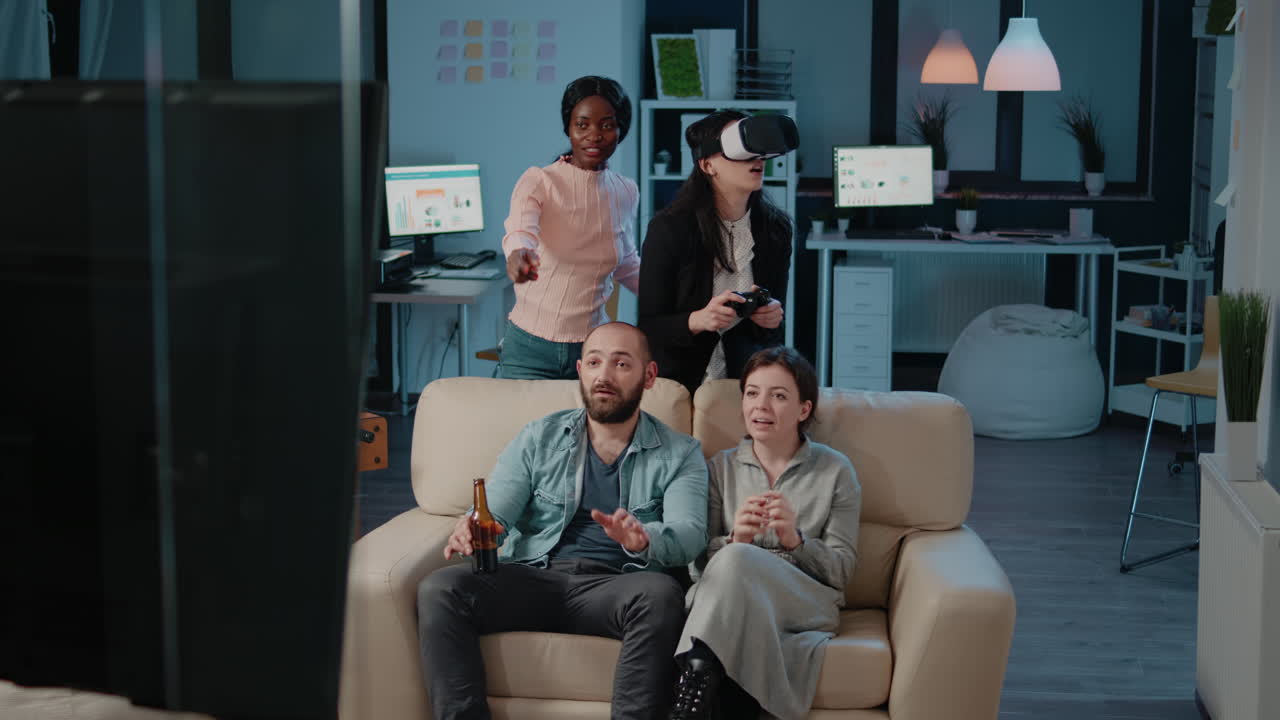 Workmates playing video games on television to have fun