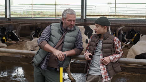 sequence of man and boy at dairy farm