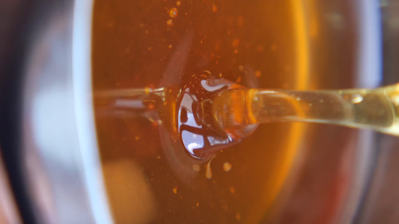 Close-up of Golden Honey Being Poured