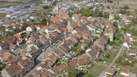 aerial side overflight of avenches medieval town and roman arena