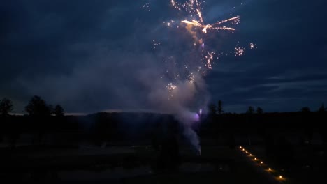 colorful fireworks launched against a dark sky during a wedding