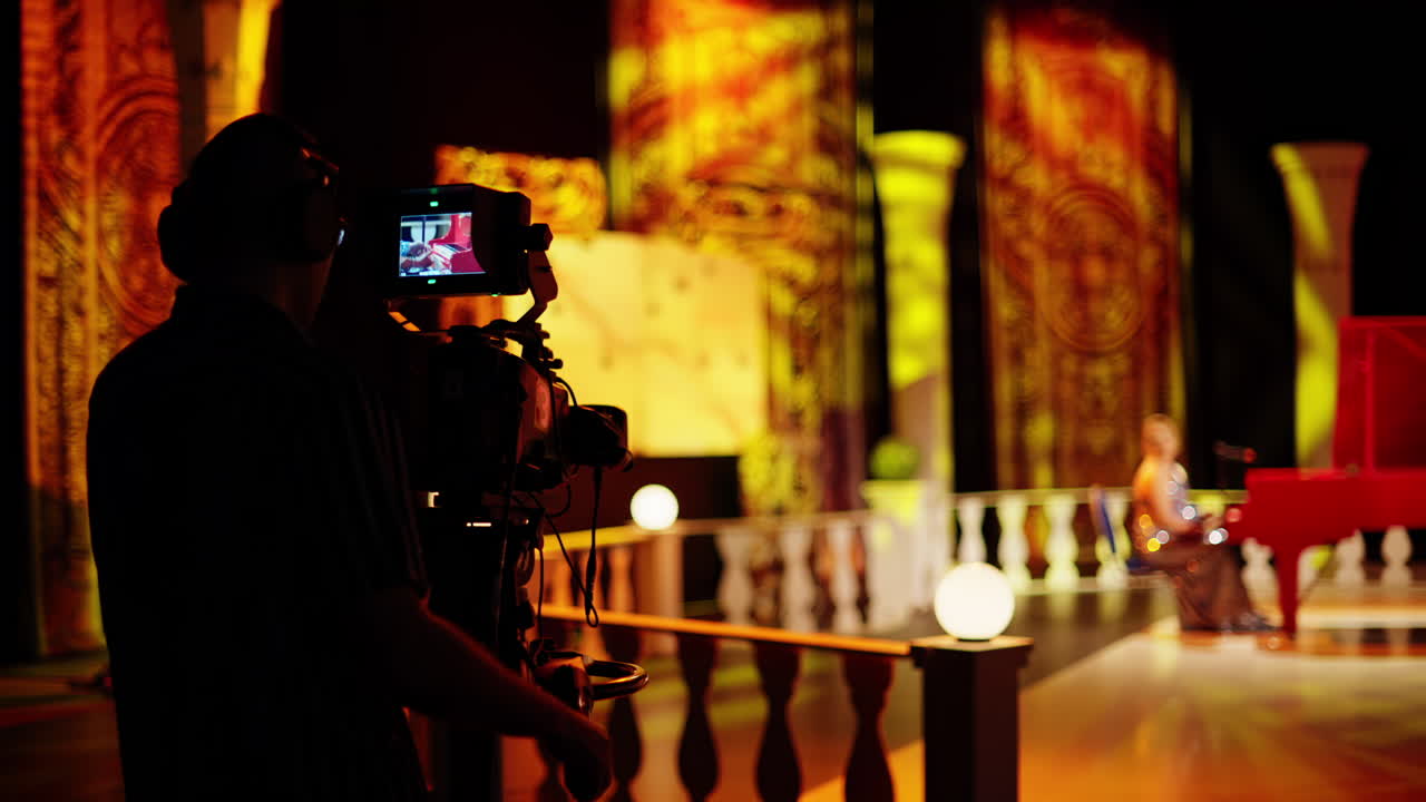 Man filming with professional camera on the backstage of a TV set