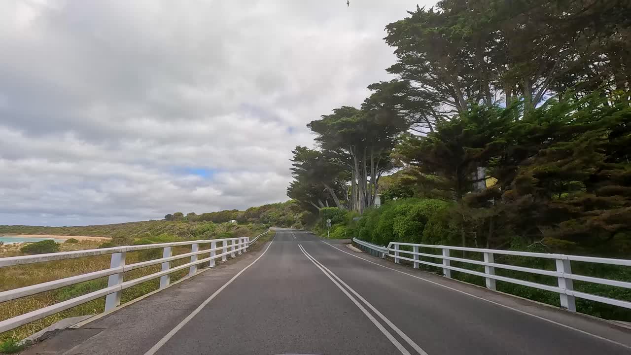 A 15-second drive showcasing lush greenery, coastal views, and winding roads under a cloudy sky on the Great Ocean Road