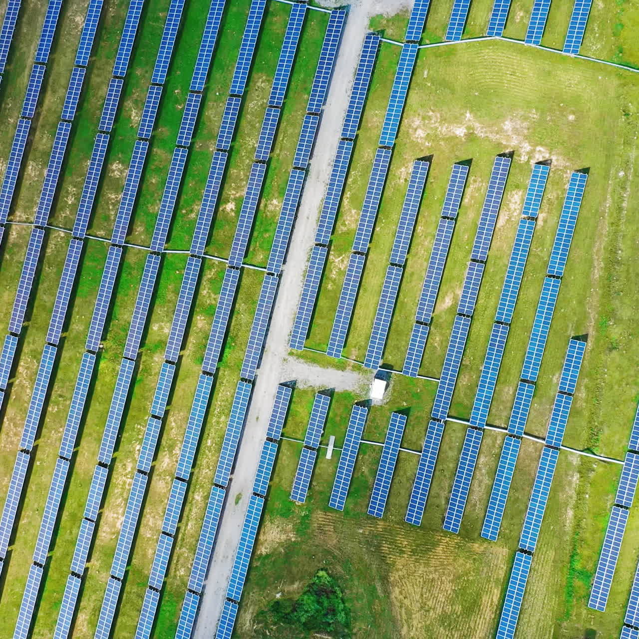 Aerial view on a modern energy farm of producing clean electricity. Ecological system of alternative energy. Slow motion. Camera moves around.