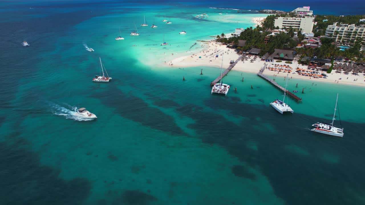 barcos de lujo amarrados en el océano azul frente a playa norte, isla mujeres, populares resorts de playa de méxico, dron 4k