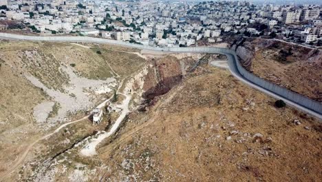 large palestinian city behind wall aerial