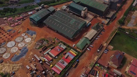 beautiful aerial of a industrial plant in rural ibadan, nigeria, africa on a sunny day. drone slowly fly across african raw material company