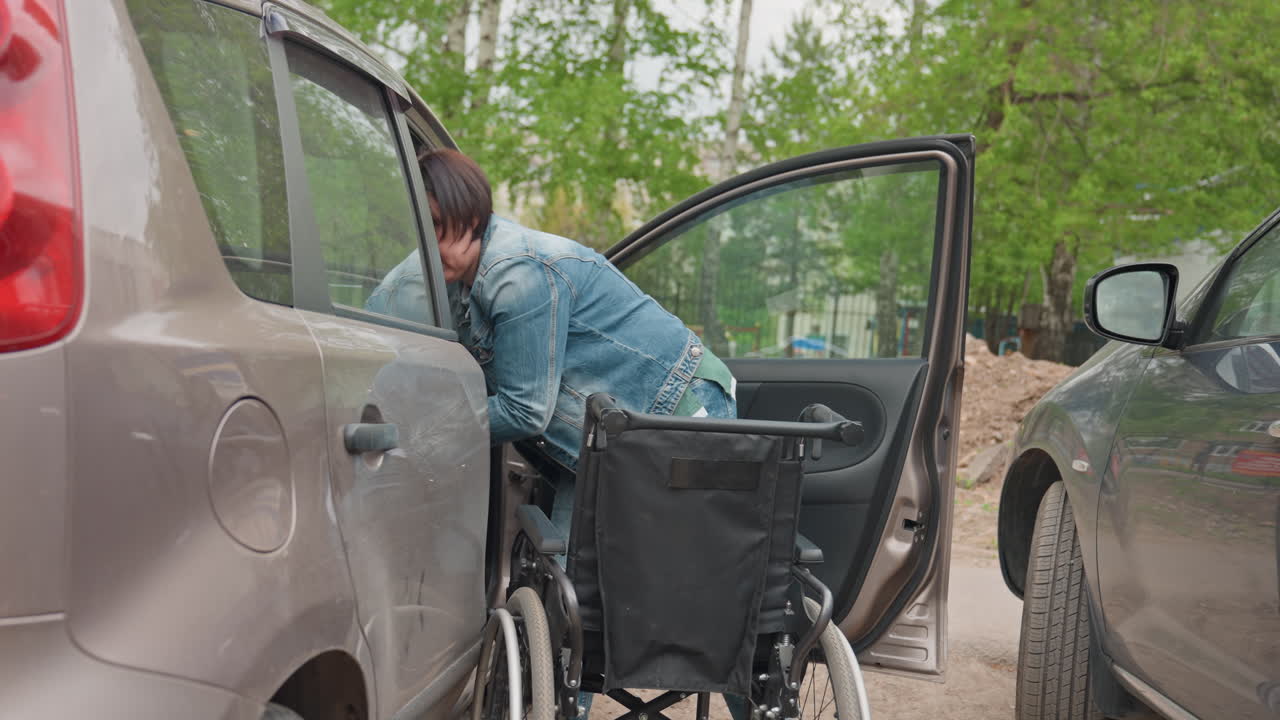 Safe Vehicle To Wheelchair Transfer, Compassionate And Secure Assistance During Patient Transfer Process, Teamwork Ensures Safe And Gentle Transfer Of Passenger From Vehicle To Wheelchair