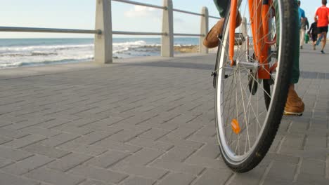 man cycling on the beach 4k