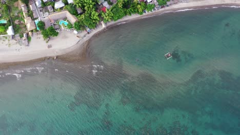 Vista-Aérea-De-Un-Pequeño-Pueblo-Con-Mar-En-Negros-Orientales,-Filipinas,-Durante-Un-Día-Soleado