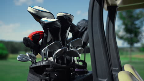 Golf-club-putters-equipment-in-cart-bag-outdoors.-Golfing-tools-in-summer-course