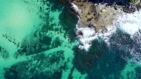 drone aerial view of crystal clear sandy reef in norah head pacific ocean central coast nsw australia 4k