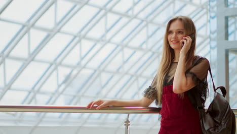 Young-attractive-girl-goes-shopping-in-mall,-talking-on-phone,-shopping-concept,-fashion-concept,-communication-concept