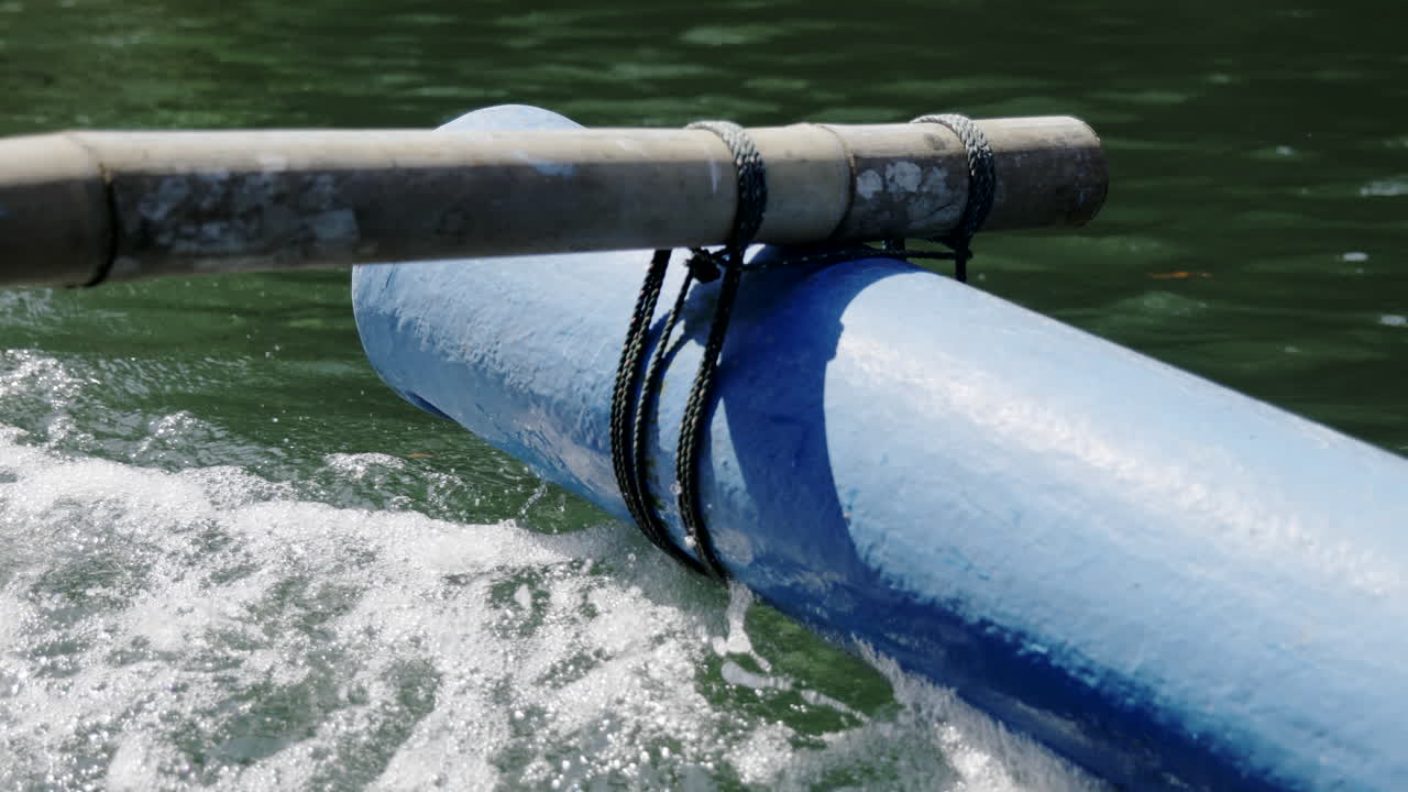 A traditional bamboo and plastic boat paddle