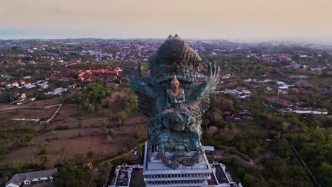 aerial footage showcases the massive garuda wisnu kencana sculpture in southern bali, rising above the cultural park and highlighting the fine details of this symbol of balinese heritage