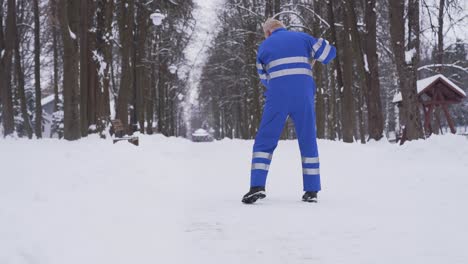 senior cleaner removing snow.