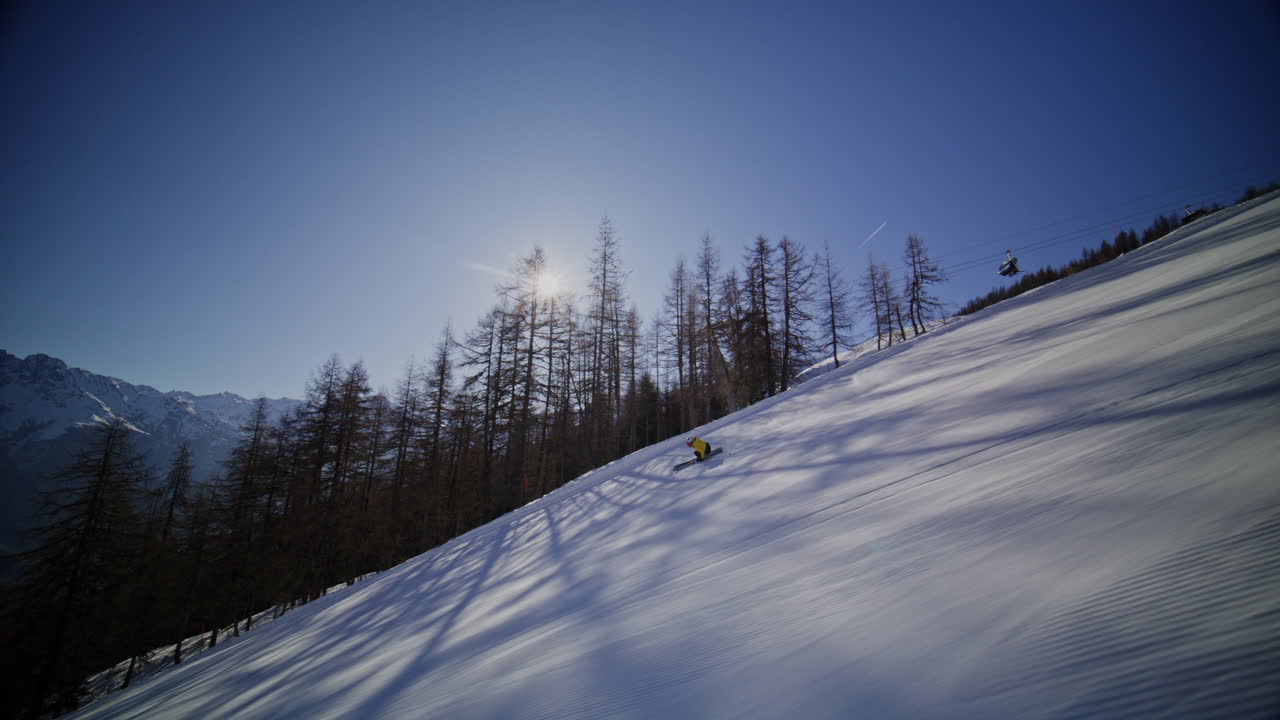 High performance alpine ski carving on groomed pistes in Verbier Bruson and Val de Bagnes filmed with drone and follow cam on a bluebird winter day showcasing fast dynamic fun skiing
