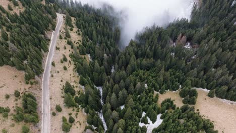 Cinematic-Shot-In-Foggy-Weather-Of-Rural-Road-In-Heart-Of-Bucegi-Mountains,-Romania