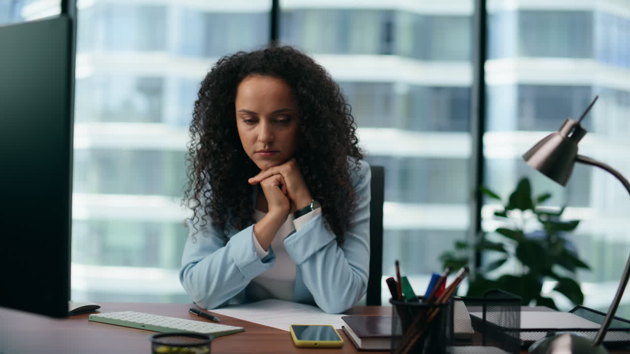 Overworked woman feeling tired in office close up. Girl suffering from headache.