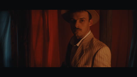 a man in hat goes inside the the circus cart and takes a photo