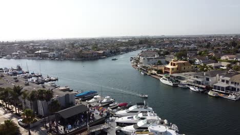 drone view of boats sailing through a marina - overhead truck shot