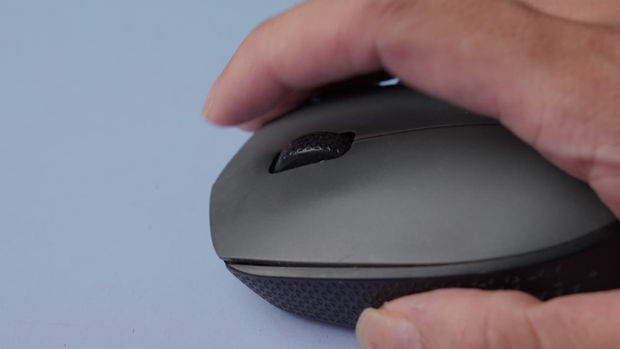 Close-up of a hand using a computer mouse