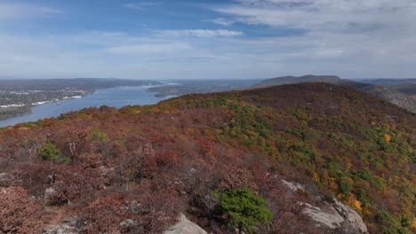 an aerial view high above the mountains in upstate ny during the fall foliage changes