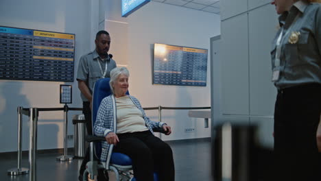 elderly woman passing through airport security checkpoint