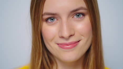 Closeup-beautiful-woman-shaking-yes-with-head-at-camera-on-grey-background.