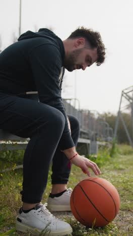 tired man rests after a tough basketball game in the park