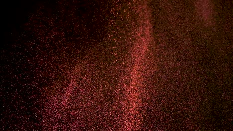 the falling red particles on the black background. slow motion