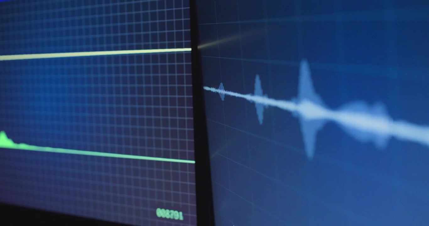 Primo piano sui monitor dello schermo desktop con la forma d'onda audio di un suono registrato in riproduzione. Produzione musicale o conversazione musicale dal vivo in studio podcast. Intercettazione di hacker, agenzia di spionaggio o attività informatica criminale