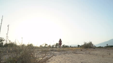 woman in a dress standing in a natural landscape