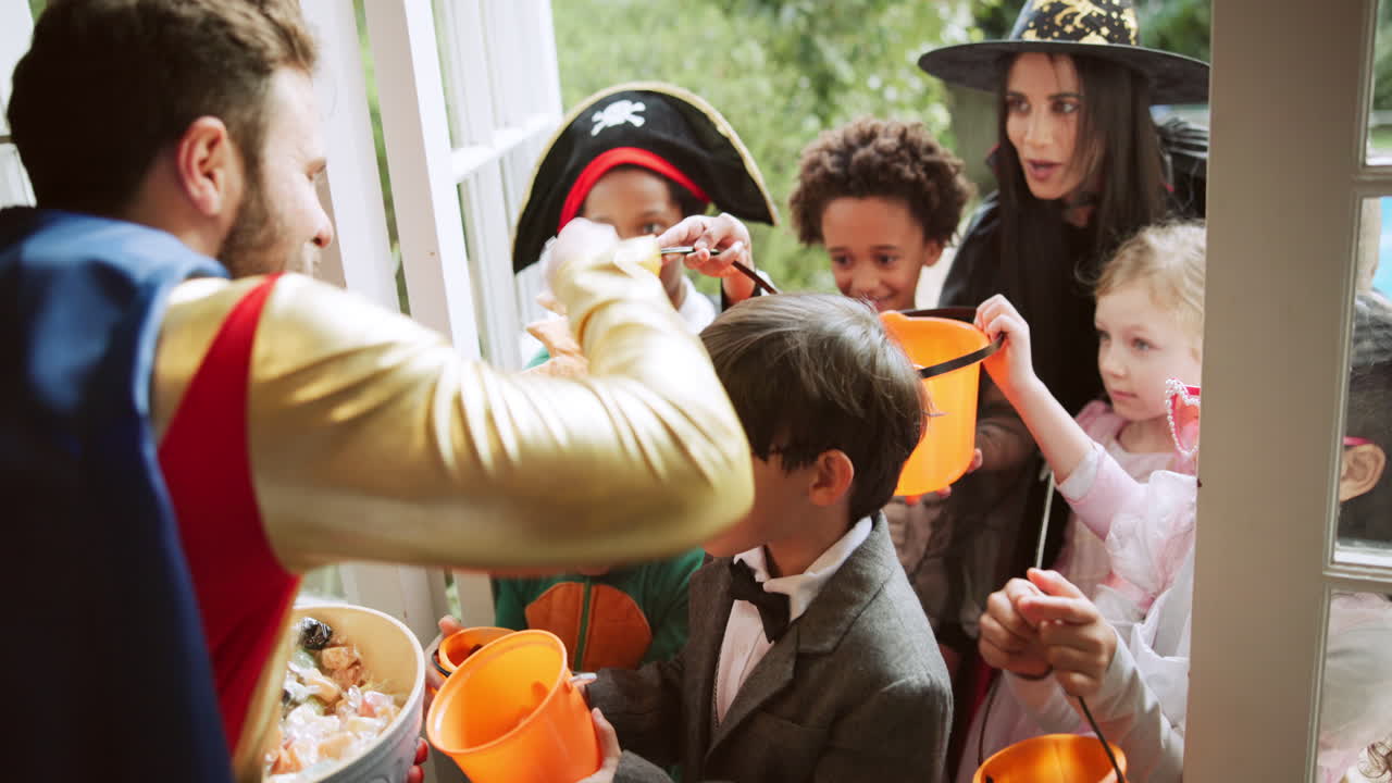 Halloween trick-or-treating with family in costumes