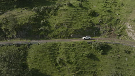 cinematic shot of a car exploring mountain road, giving the wanderlust feeling