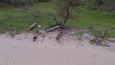 Mandorak-beach-Sumba-island-with-old-wooden-boats-during-sunrise,-aerial