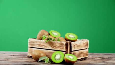 wooden box with ripe kiwi rotates slowly.