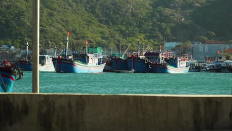 fishing boat sailing on turquoise water in port, vinh hy bay, vietnam