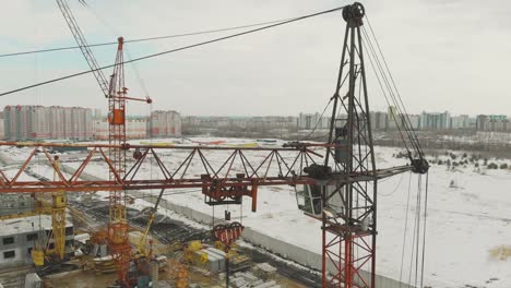 large orange construiction crane on unfinished building