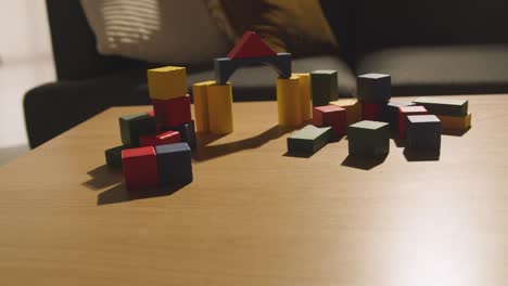 colourful wooden building blocks on table at home for learning and child diagnosed with asd 4