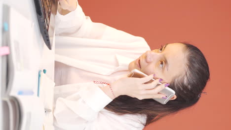 Vertical-video-of-Woman-working-hard-on-laptop.